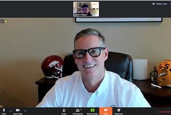 A screen-grab of a man with gray hair wearing a white polo sitting on a zoom call with another man in a small box at the top of the screen.